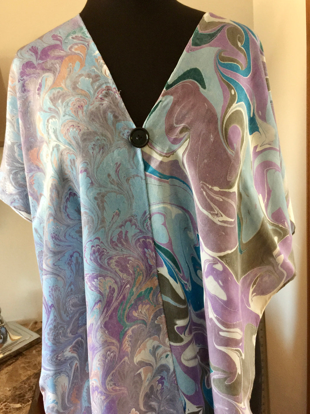 The Shibumi.  It’s a wrap, a shawl, a fashion statement!  Wear it 10 different ways!